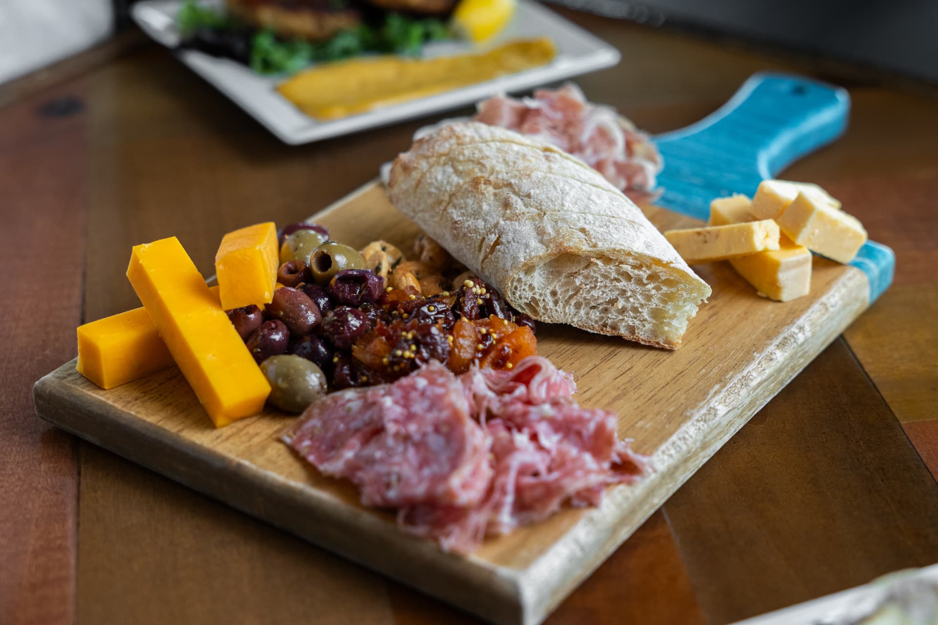 Charcuterie board with artisan cheeses, cured meats, olives, and bread