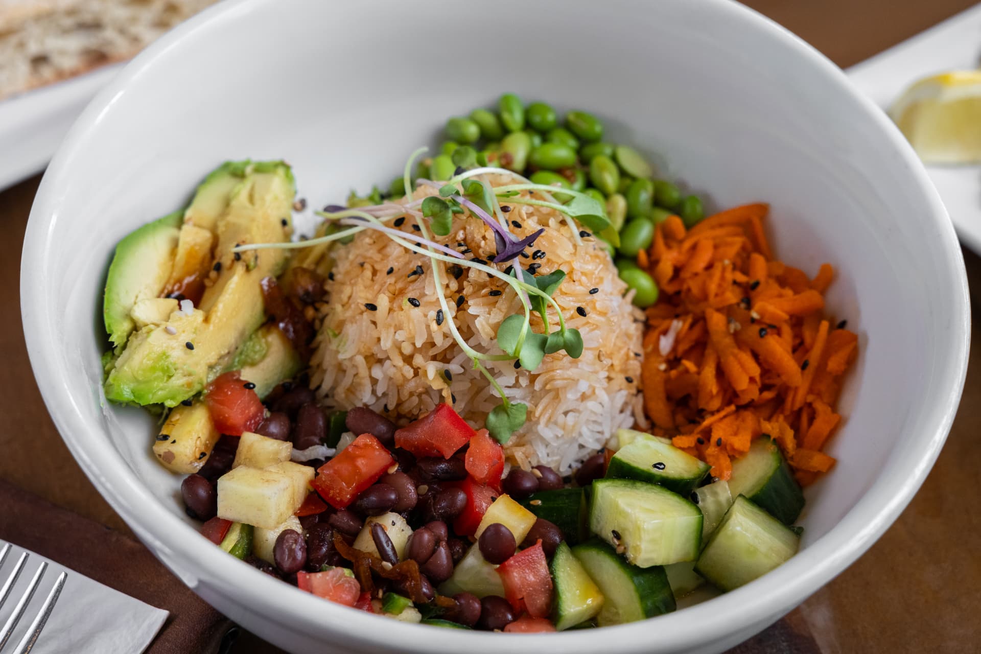 Rice bowl with jasmine rice, avocado, edamame, and fresh vegetables