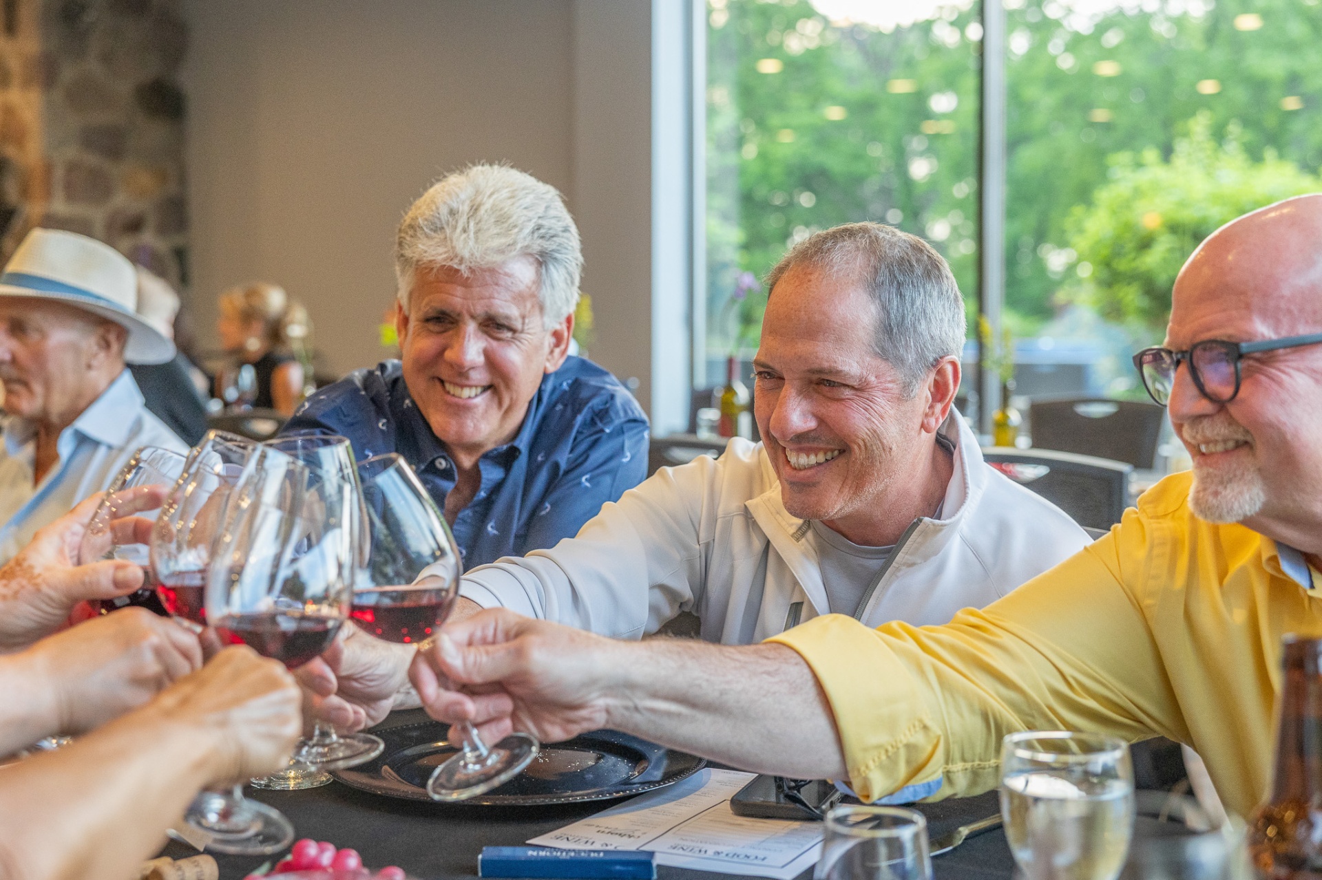 Guests sharing wine and laughter at Barrique in Lake Geneva