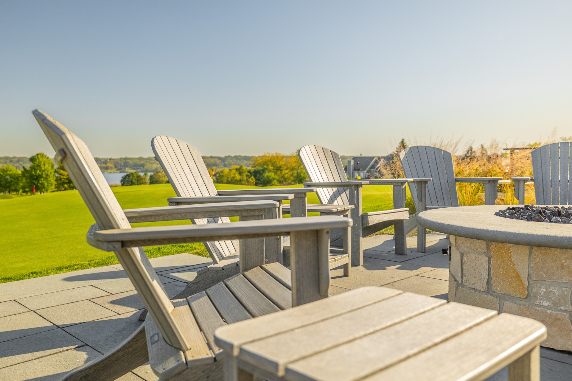 Adirondack chairs by the firepit overlooking the lake