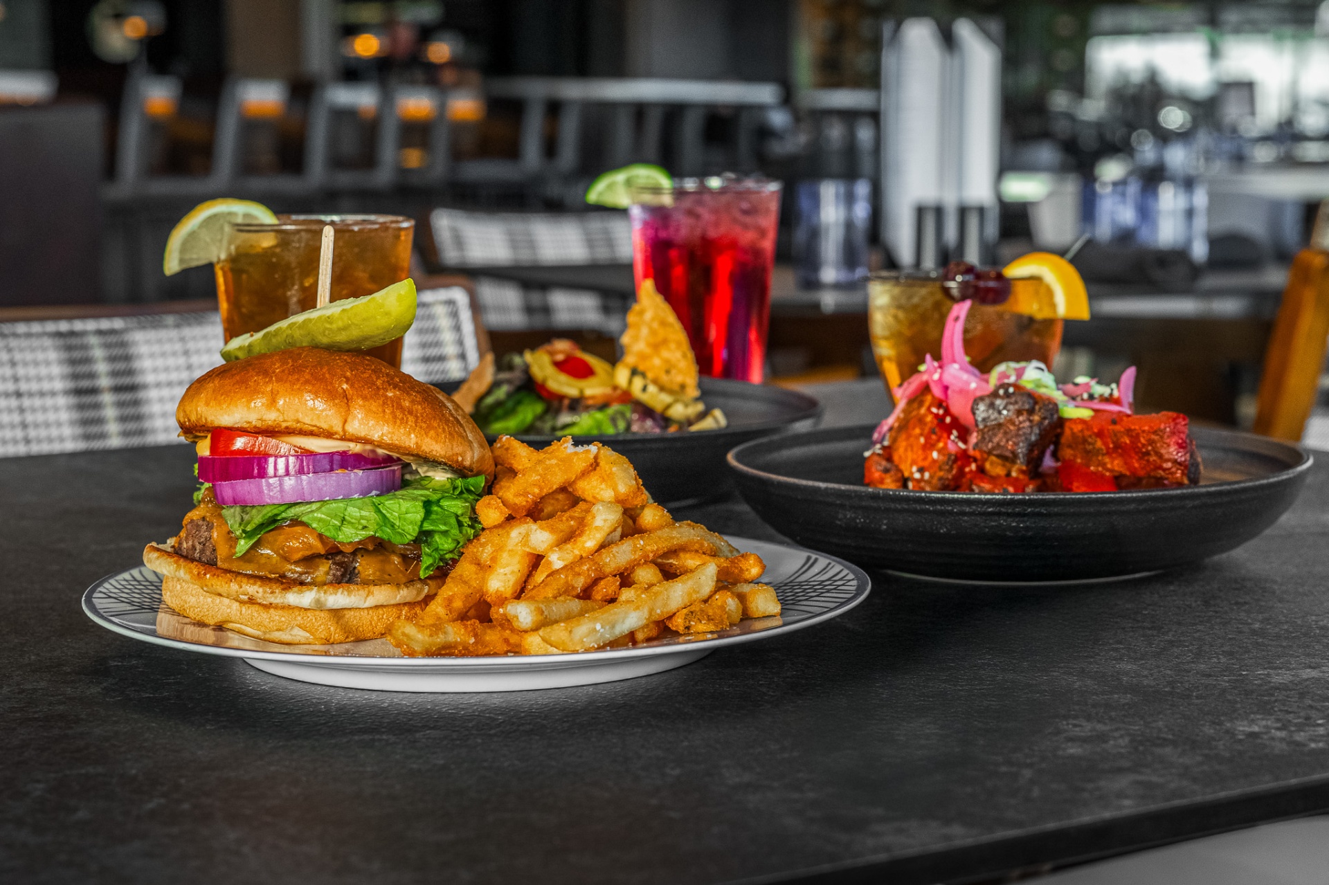 Burger and fries with cocktails on the bar